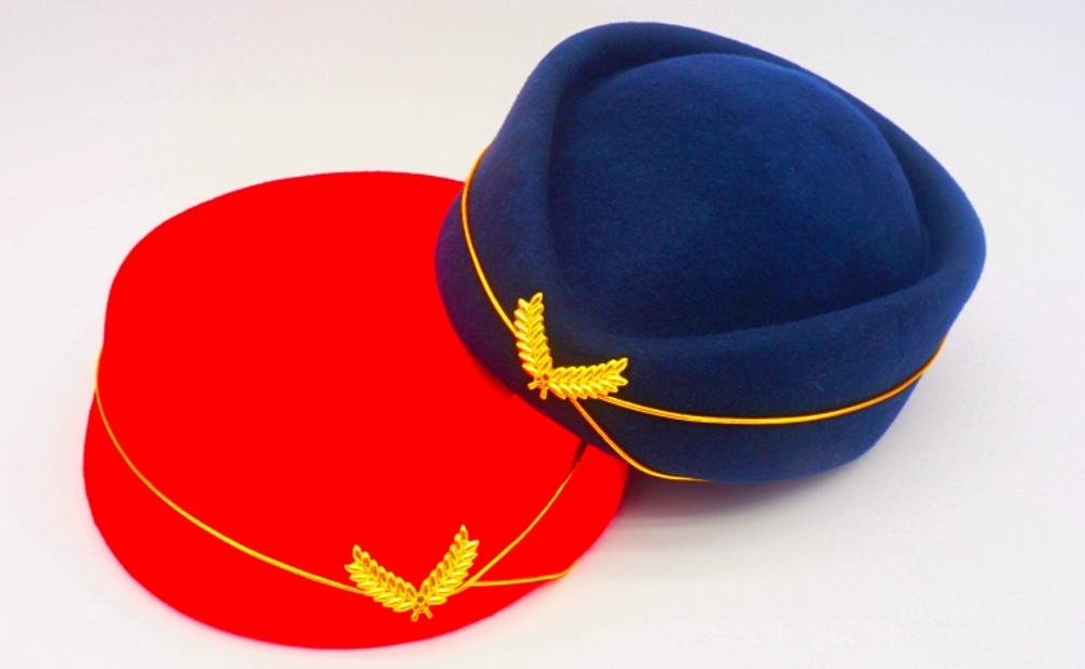 Custom fabric colors, piping and badge details for stewardess hats.jpg